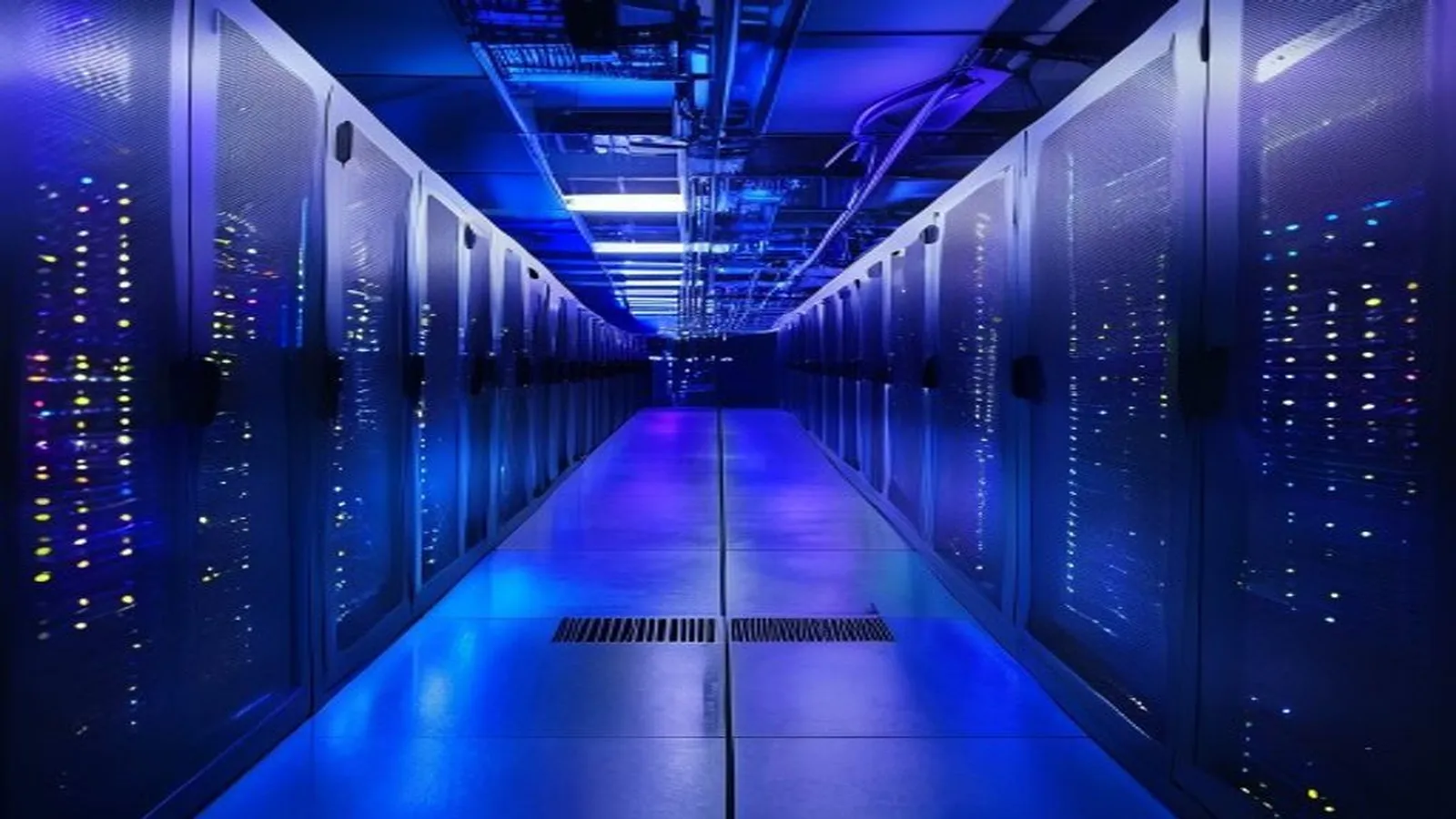 Illuminated server racks in a blue and purple data center